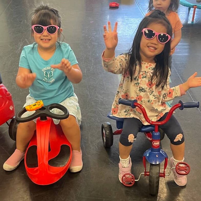 Two preschool friends on bikes at The Dance Affair Two preschool friends on bikes at The Dance Affair in San Jose